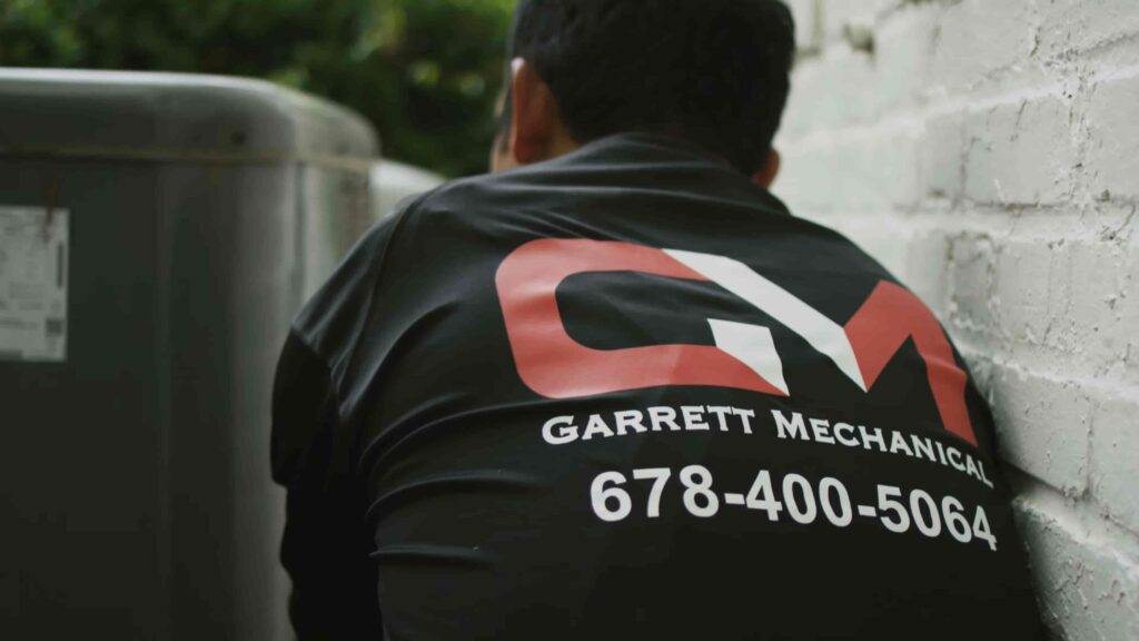 A technician working on air conditioning unit